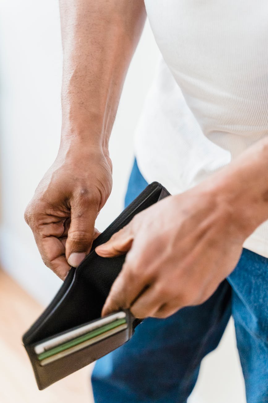 close up of man with empty wallet